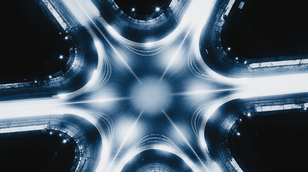 Luftaufnahme eines leuchtenden Verkehrsknotenpunkts bei Nacht, sinnbildlich für Datenströme, Vernetzung und Informationsflüsse.